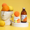 The Window, Milford Haven Vitamin C bath bomb and bath salt set with orange and lemon citrus accents on a yellow background