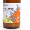 The Window, Milford Haven Vitamin C Goddess body lotion in a 250ml amber pump bottle with orange and lemon label art.