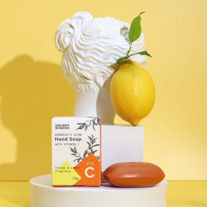 The Window, Milford Haven Vitamin C hand soap bar with citrus essential oils next to a lemon and classical bust statue.