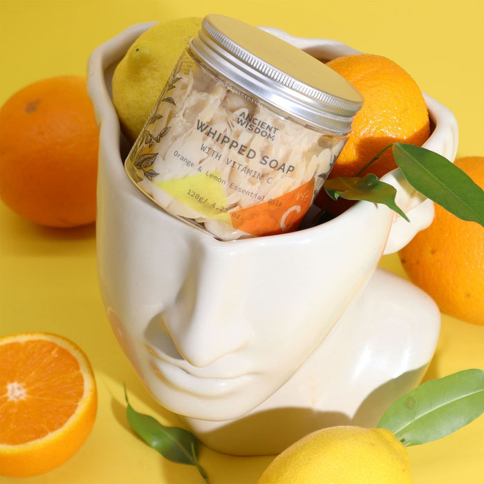 The Window, Milford Haven whipped soap jar with Vitamin C, orange, and lemon oils in a decorative head-shaped bowl.
