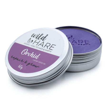The Window, Milford Haven Wild Hare Orchid solid shampoo bar in a metal travel tin with purple soap visible inside.