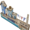 The Window, Milford Haven wooden beach house ornament with blue and white cottages, bunting, and nautical netting.
