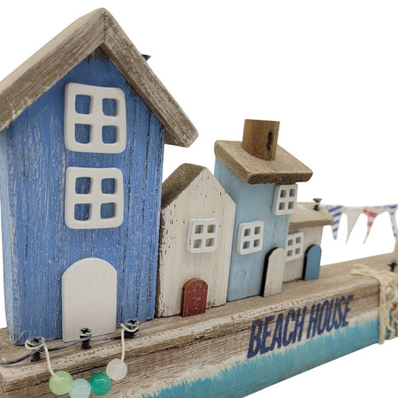 The Window, Milford Haven wooden coastal scene ornament featuring blue and white beach houses with bunting