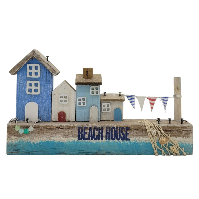 The Window, Milford Haven wooden coastal scene featuring miniature beach houses, bunting, and decorative seashells.