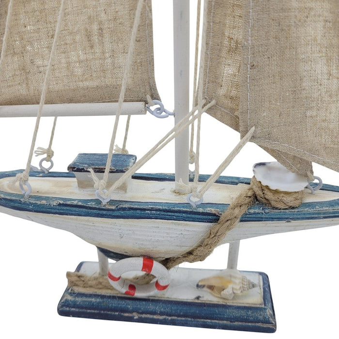 The Window, Milford Haven small wooden sailing boat ornament with fabric sails and decorative life ring detail.