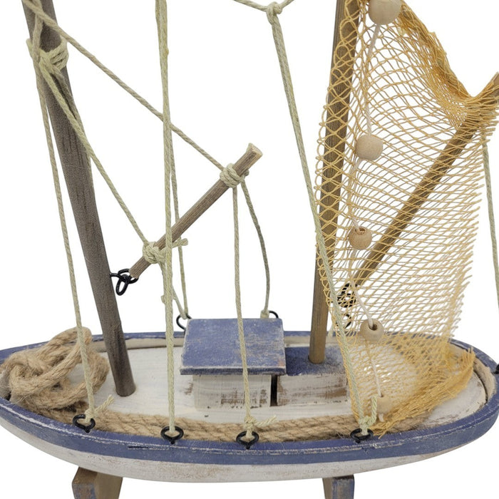 The Window, Milford Haven wooden trawler model featuring blue and white rustic finish with fibre netting and rope.