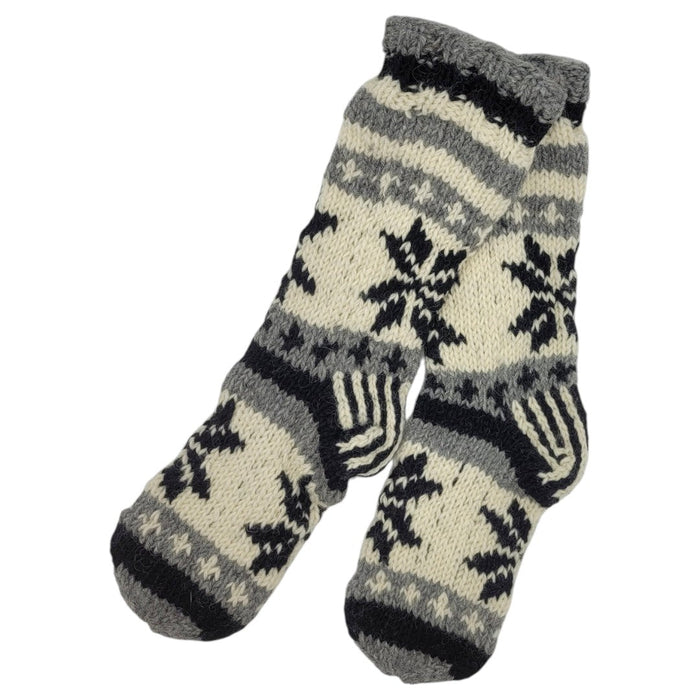 The Window, Milford Haven hand-knitted wool lounge socks in grey, white, and black with a snowflake pattern.