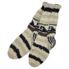 The Window, Milford Haven hand-knitted wool lounge socks in cream, grey, and black with a geometric pattern.