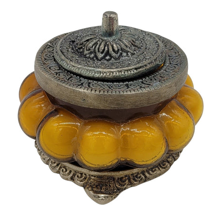 The Window, Milford Haven Precious Sandal scented soy candle in a yellow pumpkin-shaped glass jar with ornate metal lid