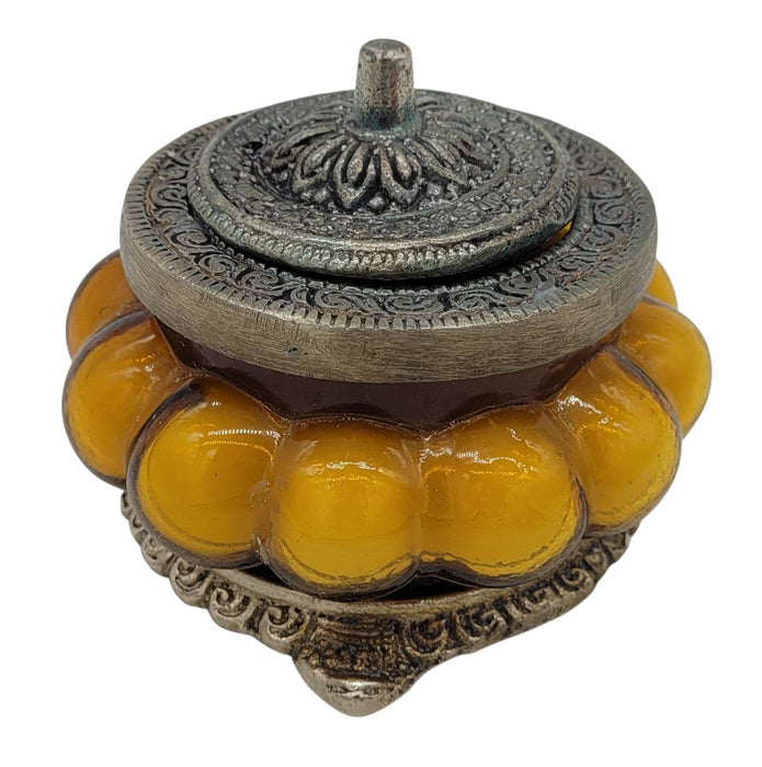 The Window, Milford Haven Precious Sandal scented soy candle in a yellow pumpkin-shaped glass jar with ornate metal lid