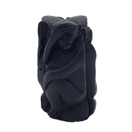 Black carved wooden figurine of a seated figure with hand on face from the three wise monkeys set