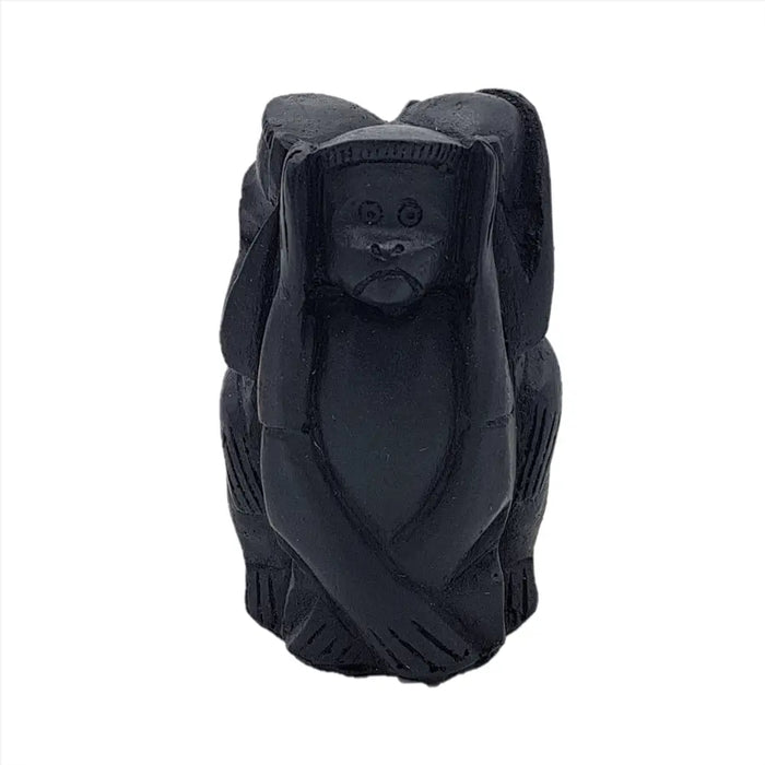 Black carved wooden figurine of a monkey covering its ears part of the three wise monkeys set three wise monkeys wise monkeys