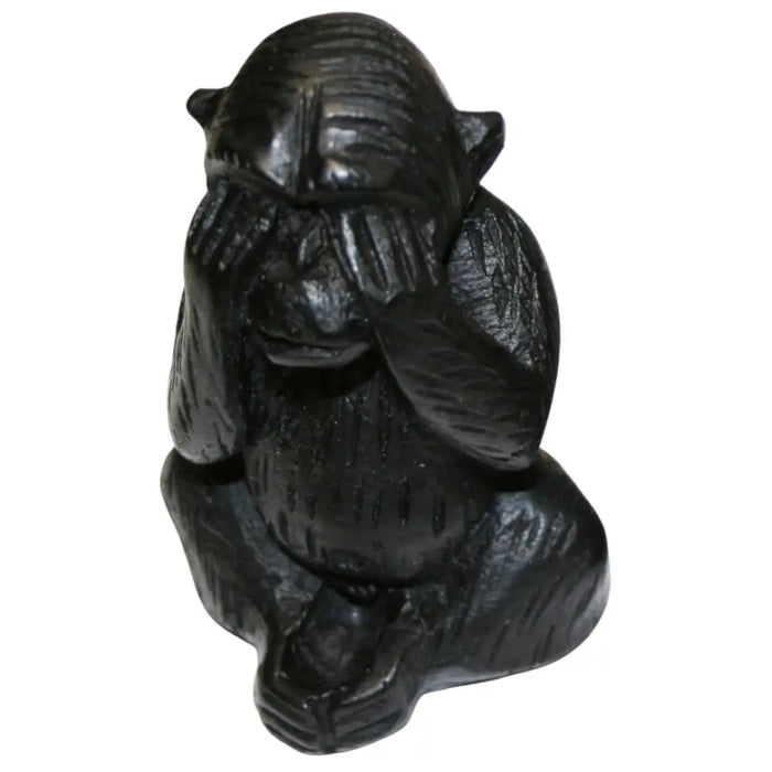 Black carved wooden three wise monkeys figurines showing hands covering eyes ears and mouth in a set of three mystic apes