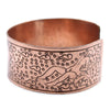 Copper wide cuff bracelet with an engraved reclining figure and swirling patterns tibetan mantra bracelet