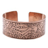 Tibetan mantra bracelet with extra wide copper band engraved with a figure swimming among bubbles and swirls