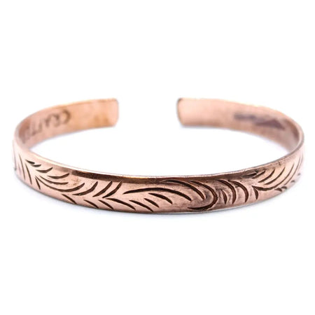 Copper tibetan mantra bracelet with engraved leaf pattern featuring tribal swirls on narrow cuff design