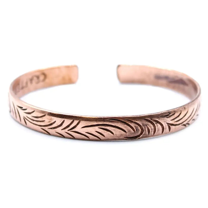 Copper tibetan mantra bracelet with engraved leaf pattern featuring tribal swirls on narrow cuff design