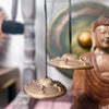 Two brass-colored tingsha cymbals with five buddhas engraving hanging by black cords