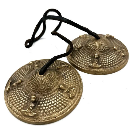 Golden brass tingsha cymbals with intricate five buddhas embossing and black leather straps