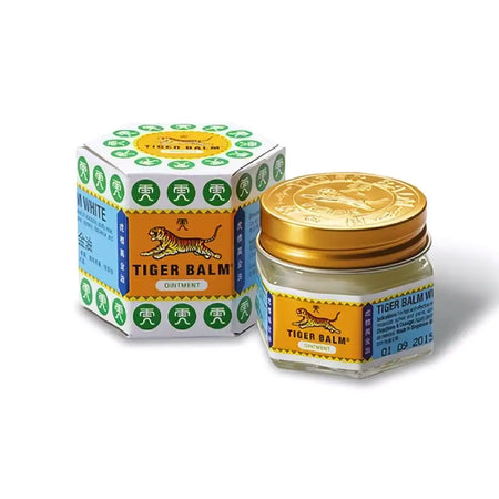The iconic hexagonal box and glass jar of tiger balm white with an orange label and gold lid