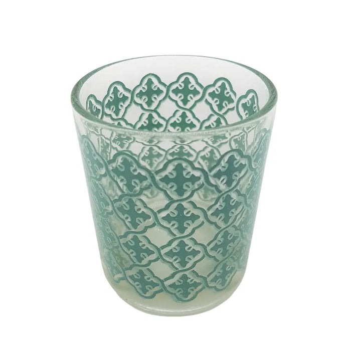 A clear glass tealight holder with a subtle green tiled pattern etched into its surface