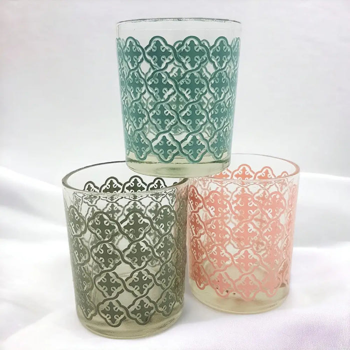 Three translucent glass tealight holders with a tiled pattern in pastel mint green dusty rose and sage gray with clear rims