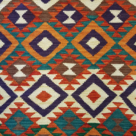 Traditional Afghan flat-weave kilim rug in vibrant orange teal purple brown and cream with wool geometric diamond motifs