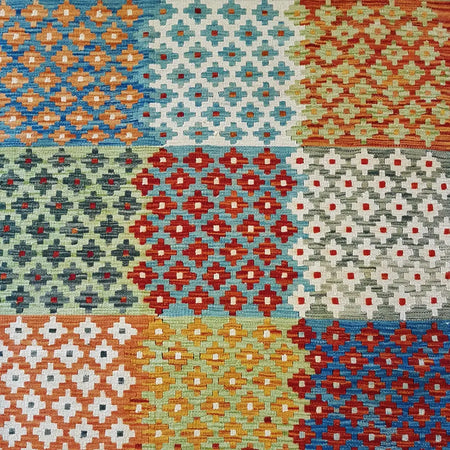 Traditional Afghan flat-weave kilim rug with vibrant orange blue red and green geometric patterns in 100 wool weave