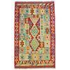 Traditional afghan flat-weave kilim rug with red and turquoise geometric pattern made of 100 percent wool and fringed edges