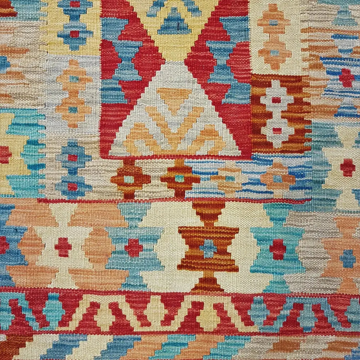 Traditional Afghan flat-weave kilim rug with vibrant red blue beige geometric patterns made from 100 percent wool