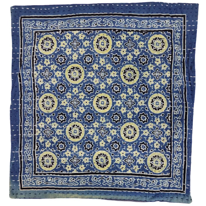 Traditional blue kantha cushion cover with yellow and black floral patterns and decorative stitching on a standard cushion