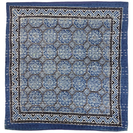 Blue and white patterned kantha cushion cover with geometric floral designs and black and white zigzag border for standard cushion