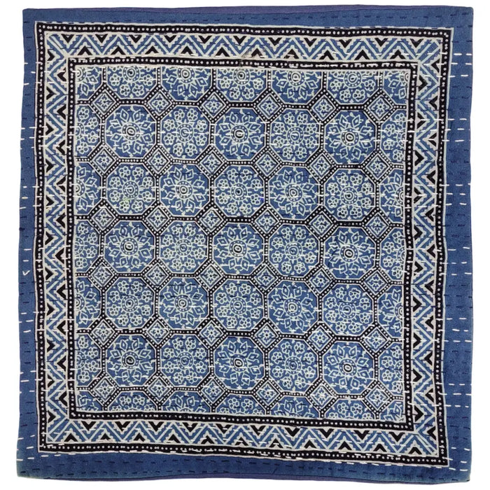 Blue and white patterned kantha cushion cover with geometric floral designs and black and white zigzag border for standard cushion
