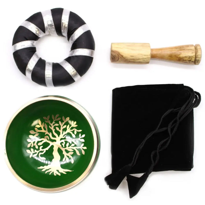 Green metallic singing bowl set with gold tree of life design made of metal for meditation and sound healing