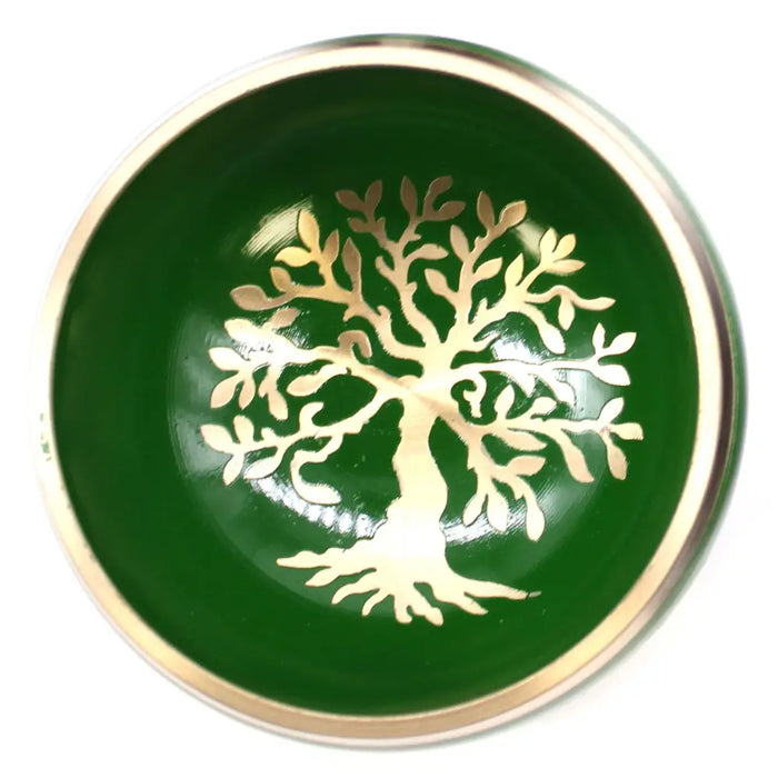 Green ceramic singing bowl set with a gold tree of life design on the bowl surface