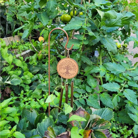 Copper-toned garden windchime with a circular wooden medallion engraved with a tree and three copper-coloured metal tubes