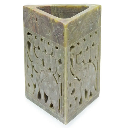Triangular soapstone oil burner in green soapstone with carved elephant and floral patterns for holding pencils