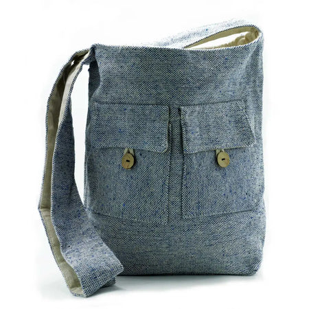 Blue-gray denim canvas bag with two front pockets secured by wooden buttons and matching adjustable strap