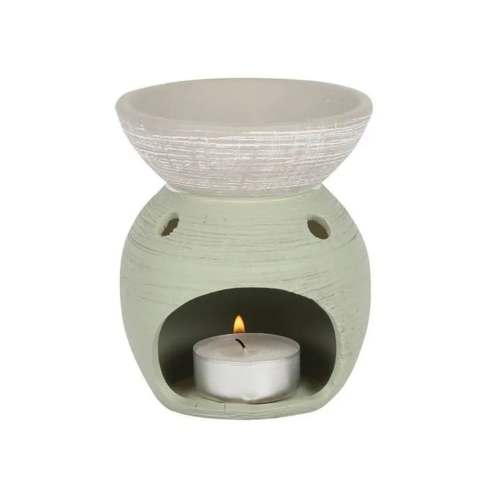A light green ceramic oil burner with a textured whitewashed bowl and two side vents in ceramic oil style