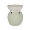 A matte sage green ceramic oil burner with a textured white bowl and two circular vents on the base