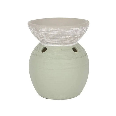 A matte sage green ceramic oil burner with a textured white bowl and two circular vents on the base