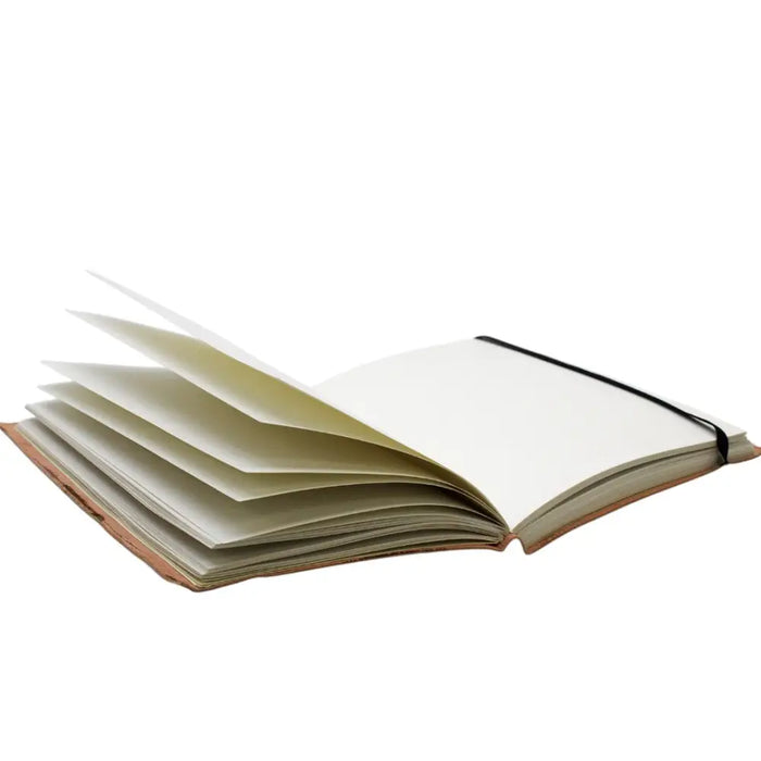 Open vegetable tanned leather medium notebook with cream pages and black elastic strap titled cosmic goddess