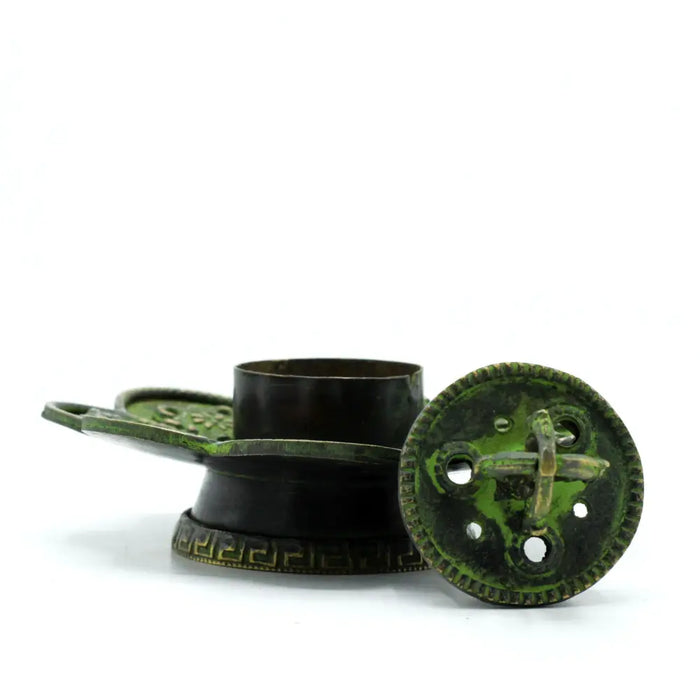 Antique green patina bronze incense holder with greek key details and circular lid featuring a cross-shaped latch