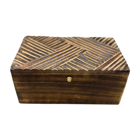 Dark brown wooden vintage deco box with a geometric antique lines pattern and a small gold knob on the lid