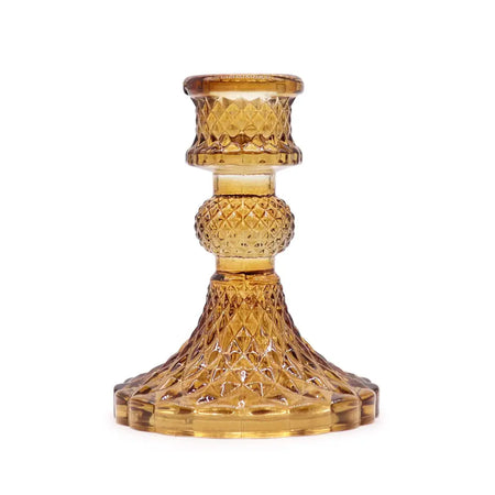 Vintage dinner candle holder in amber glass with diamond-cut patterns and a fluted base for holding candles