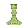 A translucent lime green glass vintage dinner candle holder with a diamond pattern and rounded bead for candles