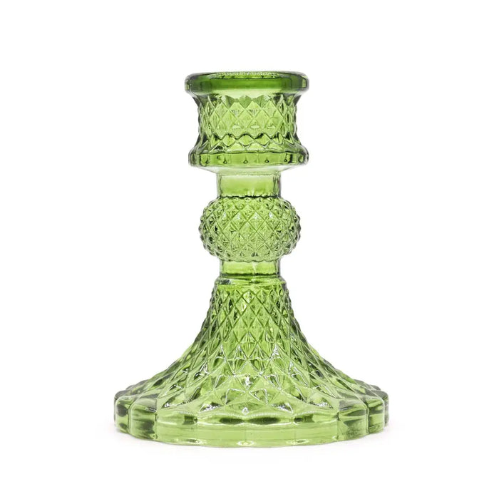A translucent lime green glass vintage dinner candle holder with a diamond pattern and rounded bead for candles
