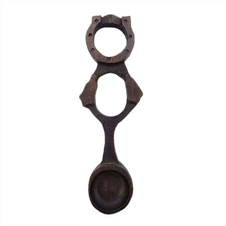 Dark brown hand-carved wooden welsh love spoon with two circular cutouts and decorative notches h17cm 5cm max spoon
