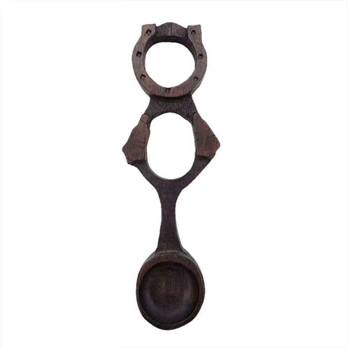 Dark brown hand-carved wooden welsh love spoon with two circular cutouts and decorative notches h17cm 5cm max spoon