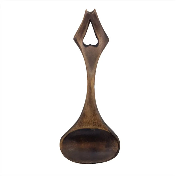 A dark brown wooden welsh love spoon with a heart-shaped cutout handle h17cm and 5cm max spoon width